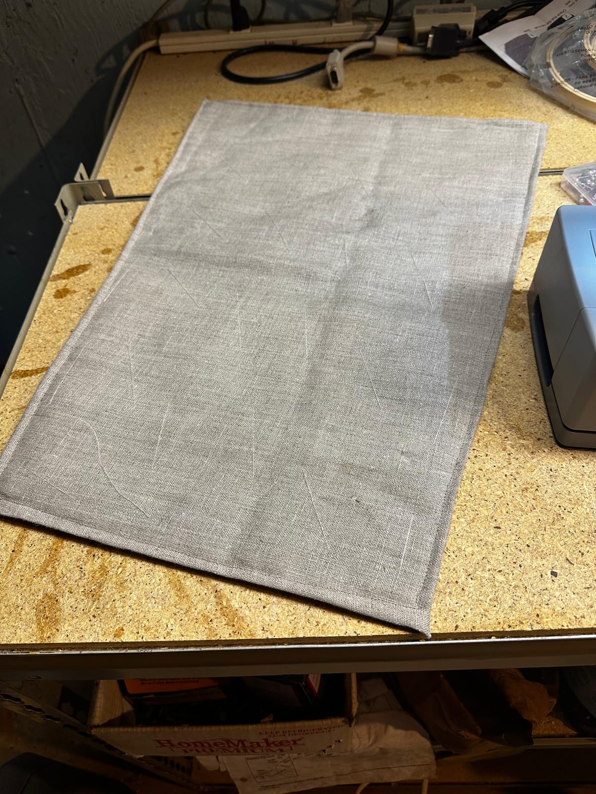An unfinished handmade gambeson sleeve made of undyed linen and wool batting